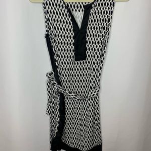 Sleeveless dress. Worn twice. Black and white with tie up belt.